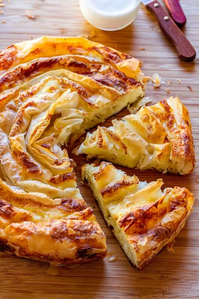 A golden-brown flaky spiral pastry