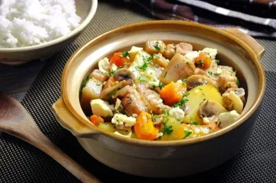 A clay pot filled with meat and vegetable stew